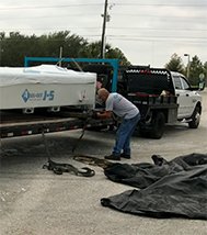 Don loading Accu-Cut machine on flat bed trailer